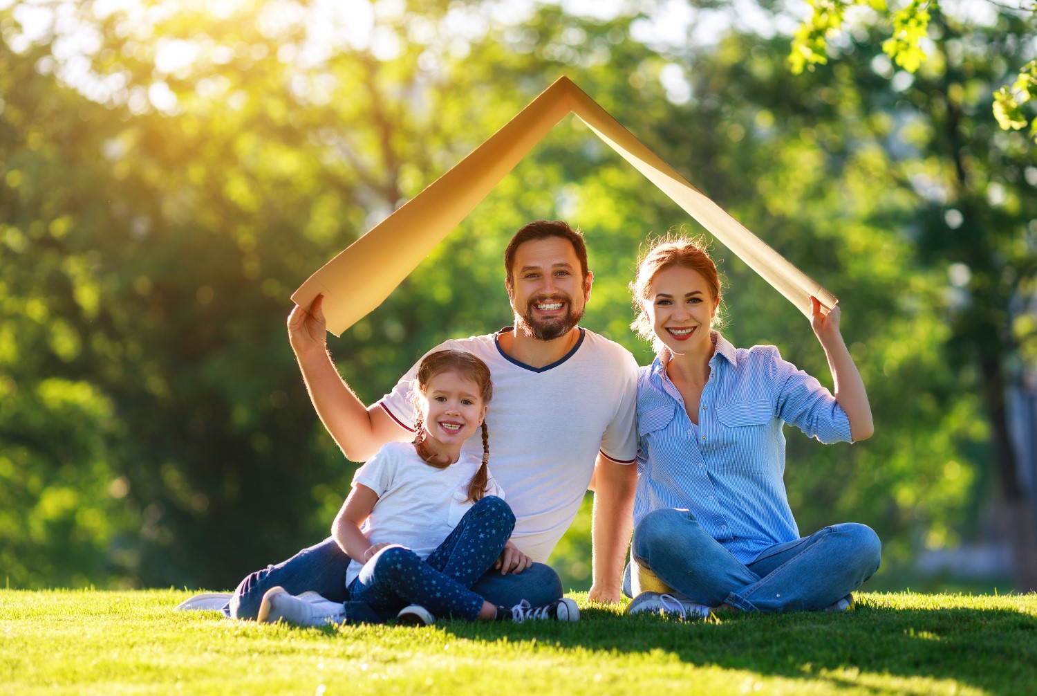 concept of mortgage and housing for families. mother father and child from roof of house on nature
