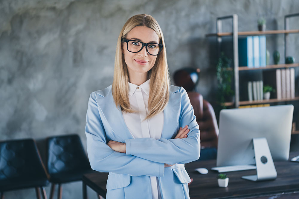 Young woman standing in an office near her workplace